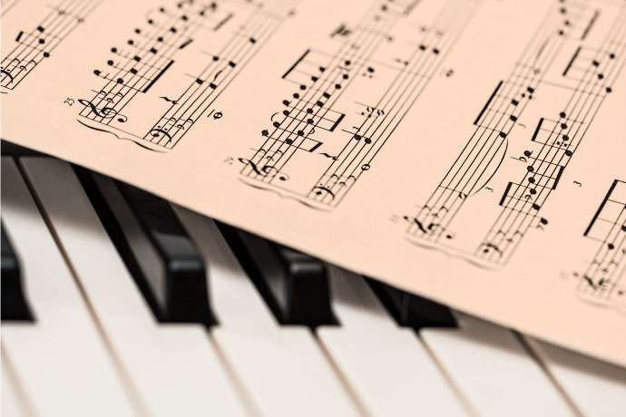 Piano chord sheet on top of piano keys